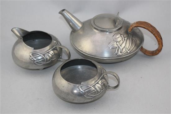 A Liberty Tudric pewter three piece tea set, no.0231, designed by Archibald Knox, teapot 9.75in.